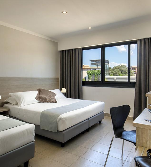 Modern, bright room with cozy beds, creating a welcoming and relaxing atmosphere.