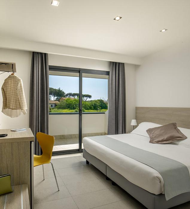 Bright, modern room with green view, cozy and relaxing.